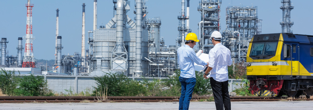 Workers in hard hats industrial logistics landscape