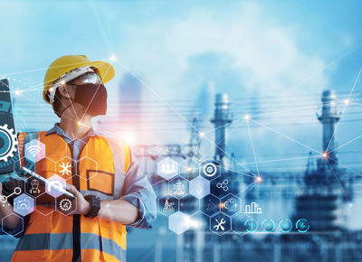 Man industrial engineer using Laptop computer checking and analysis data of power plant station project on blue background