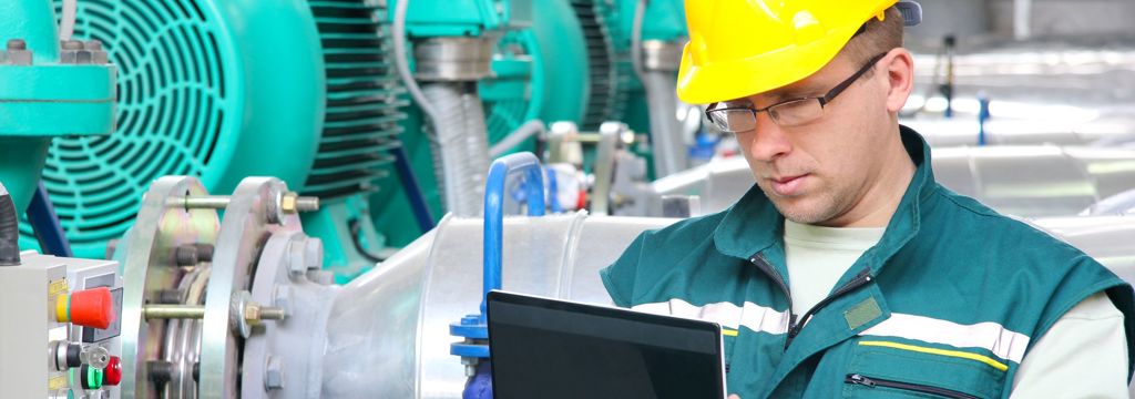 industrial worker onsite with hardhat and tablet