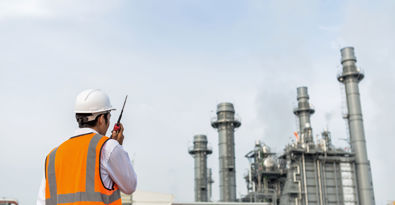 Engineer in uniform and helmet on of background the construction site power plant