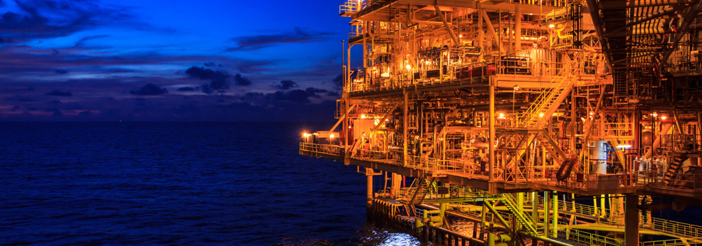 offshore rig, at night with lights on