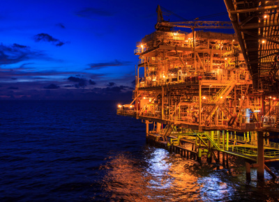offshore rig, at night with lights on