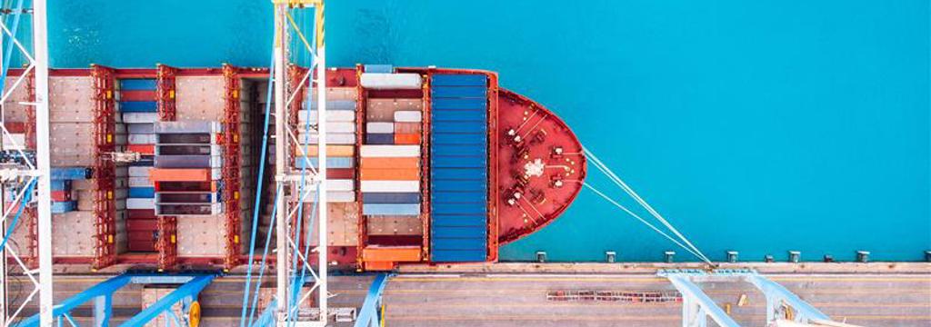 Birds eye view of a ship docked in an industrial port