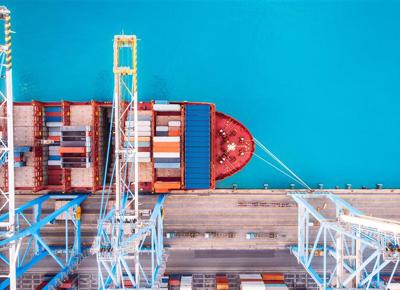 Birds eye view of a ship docked in an industrial port